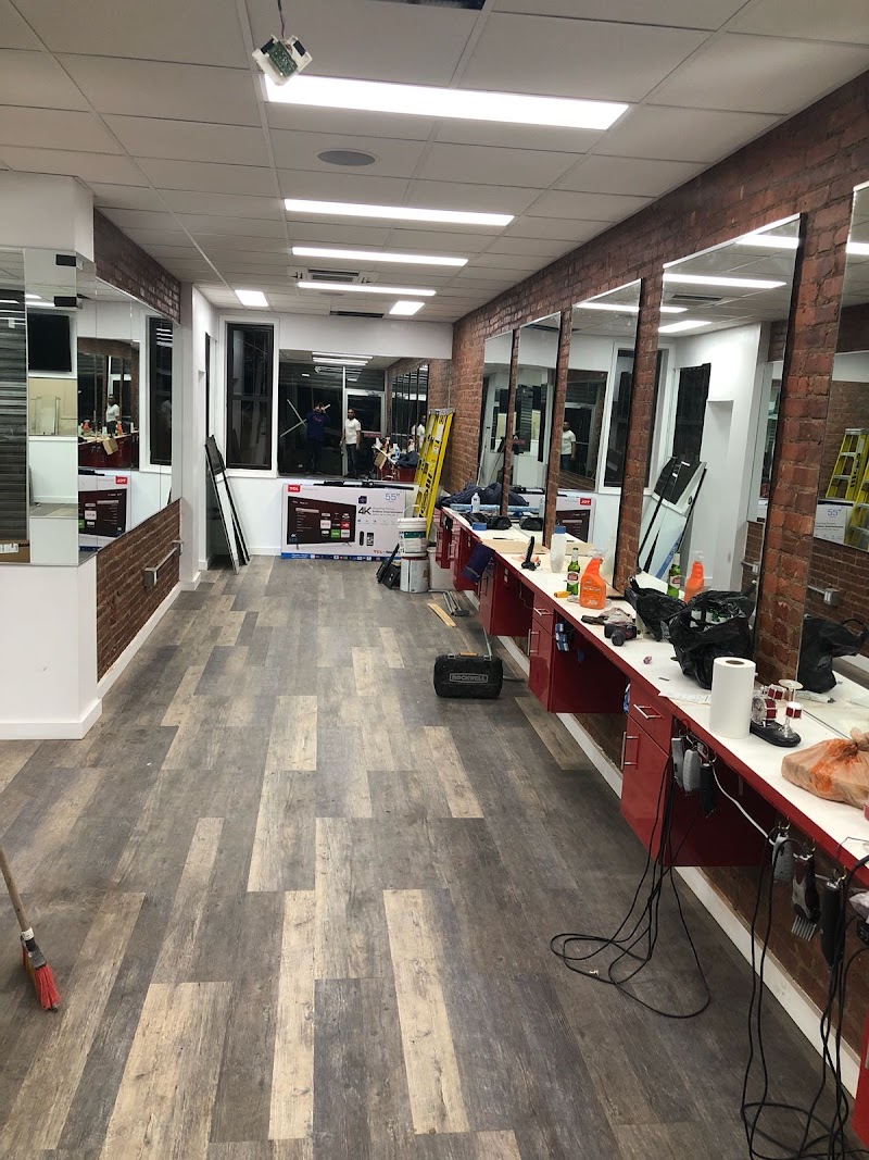 Lugo Barber Shop interior — brick and red cabinets